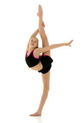 Obraz premium Gymnast Girl Doing Vertical Splits Holding her Leg up with Her Hand