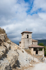 Beautiful old church of stone in Merindades. Blue sky with clouds, Burgos, Spain, Europe.