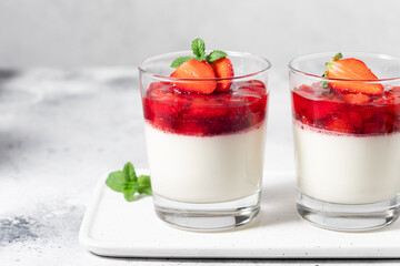 Vegan coconut panna cotta with strawberry sauce in glasses. Vegan food concept. close-up, copy space