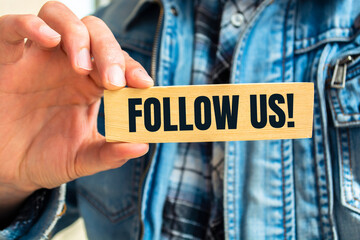 Man holding a card with the text Follow us on white background