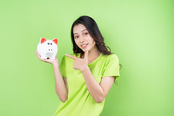 asian girl holding piggy bank in her hand money saving concept