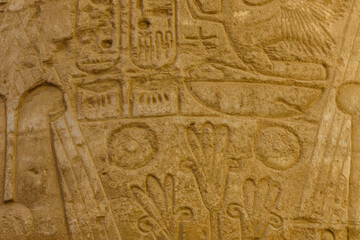 Fototapeta na wymiar Egyptian ancient hieroglyphs on the stone wall