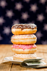 Donuts and money on american flag background	