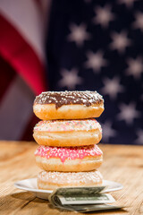 Donuts and money on american flag background	