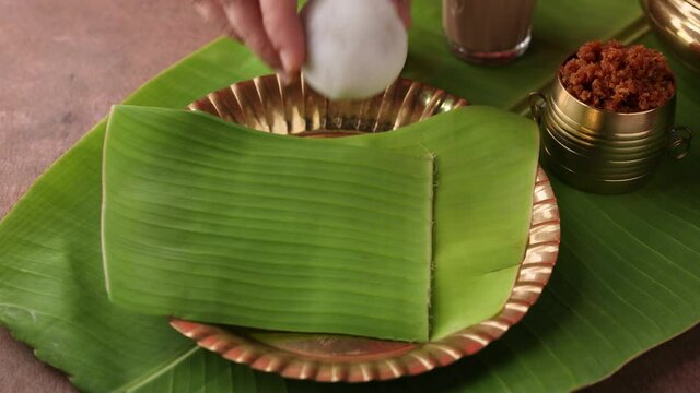 Kozhukatta Pidi golden bowl Indian milk tea Kerala tea time snack steamed food hand sweet modak rice dumpling Ganesh Festival India sweet mithai 4K slow motion video footage christian food Palm sunday