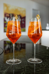 Celebrating with refreshing spritz on smaragd green marble table cocktail glass