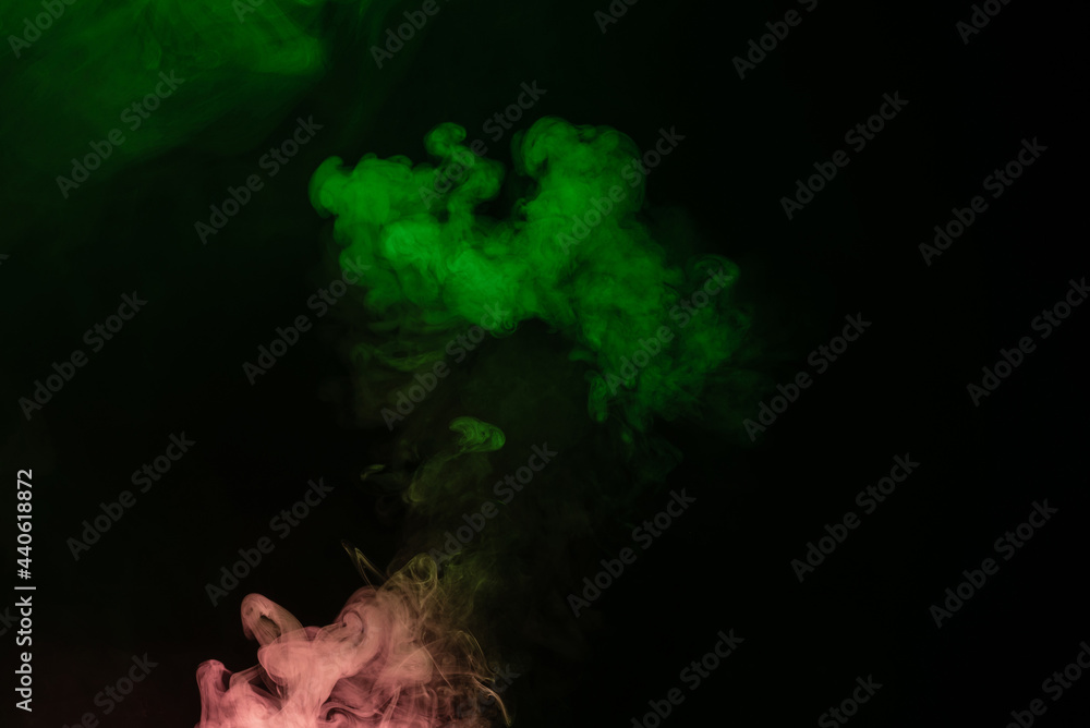 Wall mural green and pink steam on a black background.