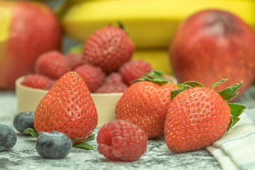 Berries and fruits on the table for making a cocktail