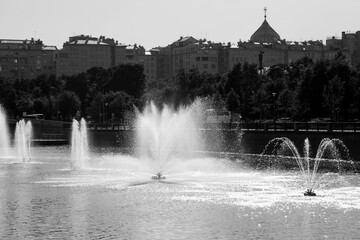 Row of Water fountains in the middle of Moscow river, monochrome Moscow, Russia