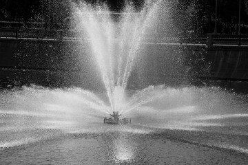 Water fountain in the middle of Moscow river, monochrome Moscow, Russia.