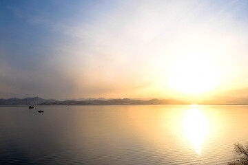 Naklejka premium Sunset view of the Avacha Bay. Ships standing in the roadstead, mountains in the background. Petropavlovsk-Kamchatsky, Kamchatka Peninsula, Russia.