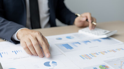 Financial businessman analyze the graph of the company's performance to create profits and growth, Market research reports and income statistics, Financial and Accounting concept.