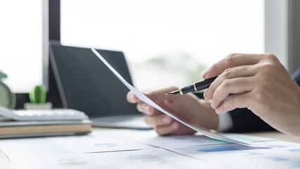 Financial businessman analyze the graph of the company's performance to create profits and growth, Market research reports and income statistics, Financial and Accounting concept.