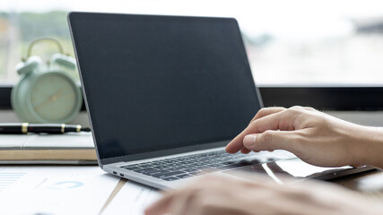 Businessman's hand presses on a laptop keyboard, World of technology and internet communication, Using computers to conduct financial transactions because the convenience and speed.