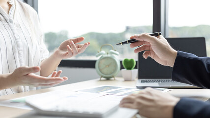 Brainstorm team, Marketers and financial accountants are discussing and analyzing charts to plan strategies to meet customer needs, Team meetings or business consulting.