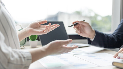 Brainstorm team, Marketers and financial accountants are discussing and analyzing charts to plan strategies to meet customer needs, Team meetings or business consulting.