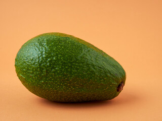 Organic avocado with seeds, avocado halves and whole fruit on a yellow background. Top view. Pop art design, creative concept of summer food.