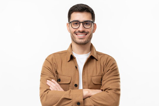 Young handsome smiling man in brown shirt and glasses, feeling confident, isolated on gray background - Powered by Adobe