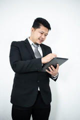 Smiling portrait of businessman with touchscreen tablet device in business suit isolated in studio