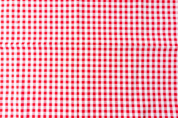 A crumpled dining tablecloth with a white and red checker pattern is the background. Top view for...