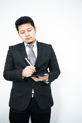 Smiling portrait of businessman with touchscreen tablet device in business suit isolated in studio