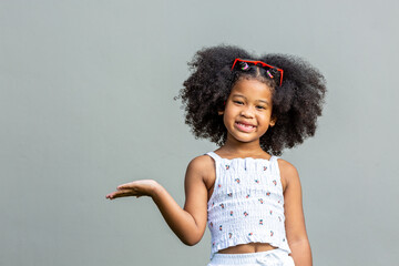 child woman afro hairstyle afro wearing red glasses showing emotionc and poses Isolated on gray...