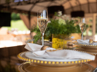 A glass of champagne on the terrace in an expensive restaurant on a set table for guests of honor.