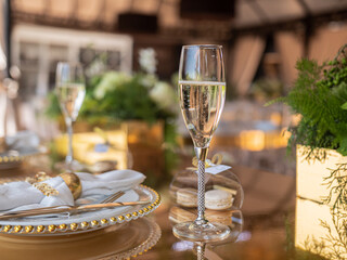 A glass of champagne on the terrace in an expensive restaurant on a set table for guests of honor.