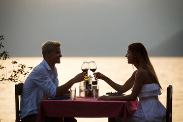 Couple sharing romantic sunset dinner on tropical resort