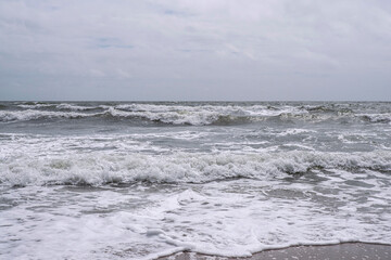 Close-up of waves on a sandy beach in Brittany