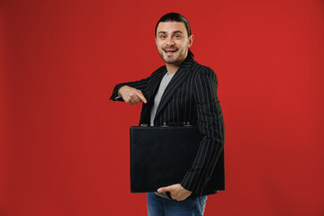 Young smiling successful businessman latin man 20s with ponytail wearing black striped jacket grey...