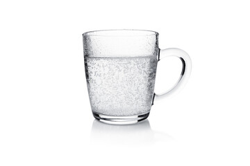 Transparent mug with bubbling water isolated on white