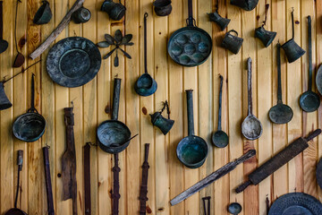 Ancient kitchen utensil hanging on wall. Kitchenware of the yoruk tribe