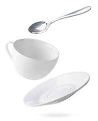 Empty dishes cup, plate and spoon are flying on a white. Isolated