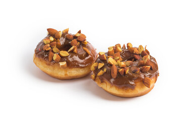 Doughnuts chocolate glazed and nuts covered in composition at studio shot