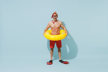 Full length young sexy strong sporty man in red shorts swimsuit diving mask relax near pool hold...