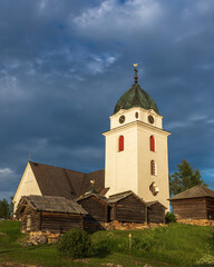 Fototapeta premium church and wooden cabins in the Swedish countryside