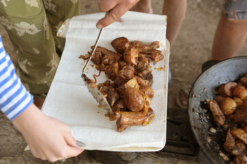 The prepared dish is fried potatoes, the meat is spread on the pita bread.