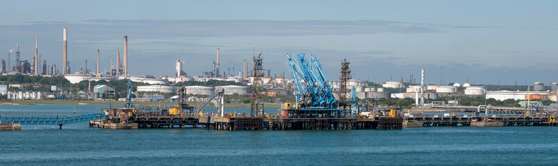 England, UK. 2021.  Fuel loading jetty at a refinery with a background of fuel storage tanks.