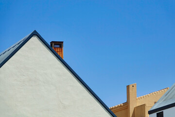 Fototapeta na wymiar Slate roofs with chimneys on a sunny day