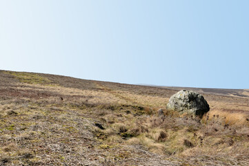 pennine landscape with large old boulder or standing stone on midgley moor in west yorkshire