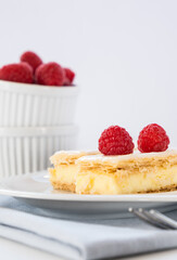 Vanilla custard slice with icing and fresh raspberries, close up