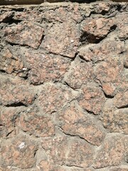The texture of a stone wall. Background texture of the stone wall of an old gray building. A stone wall as a background or texture.