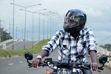 Fototapeta na wymiar African biker man in the helmet riding