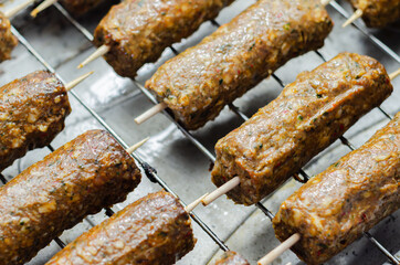 Minced and shaped lamb kebabs with chilli and coriander prepared for grill