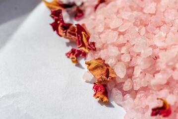 Macro salt crystals with crushed flower petals. Bath salt. Blurry background and shallow depth of...