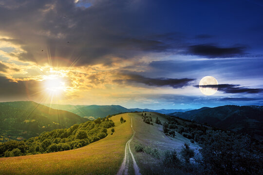 day and night time change concept above road through meadow in mountains. beautiful rural landscape of carpathians with sun and moon. wonderful summer weather with fluffy clouds on the sky