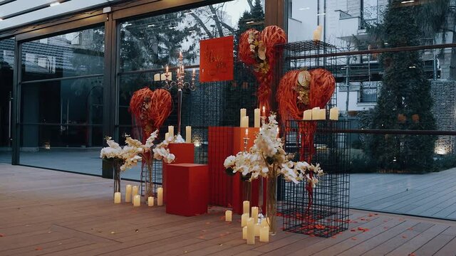 Love transposed by candles, flowers and heart-shaped ornaments. The concept of love. 4k portrait