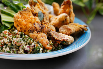 Chicken nuggets with porridge and fresh vegetable salad.