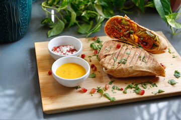 Falafel in tortilla with vegetables. Vegetarian cooking. Vegetarian fast food.
A colorful appetizing dish. Culinary photography, food styling.